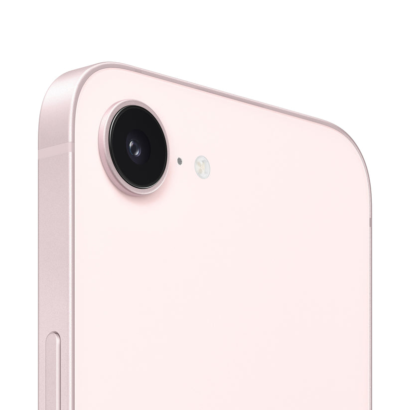 A close-up view of the pink smartphone's rear camera module, highlighting the single protruding lens, a tiny microphone hole, and the adjacent circular flash ring.