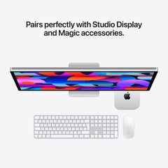 An overhead shot of a desktop setup featuring the Mac mini paired with a Studio Display, Magic Keyboard, and Magic Mouse.
