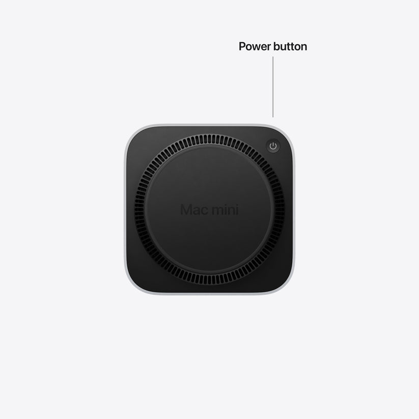 An underside view of the Mac mini highlighting the location of the power button and ventilation vents.