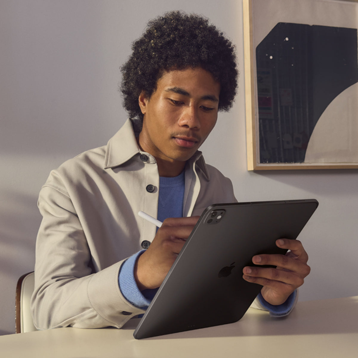 Man writing notes with Apple Pencil on Apple iPad Pro M5 13-inch 1TB Standard Glass Silver at Tradeline.