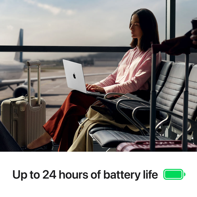 Woman traveling in an airport using 14-inch MacBook Pro M5 Space Black with 24-hour battery at Tradeline.